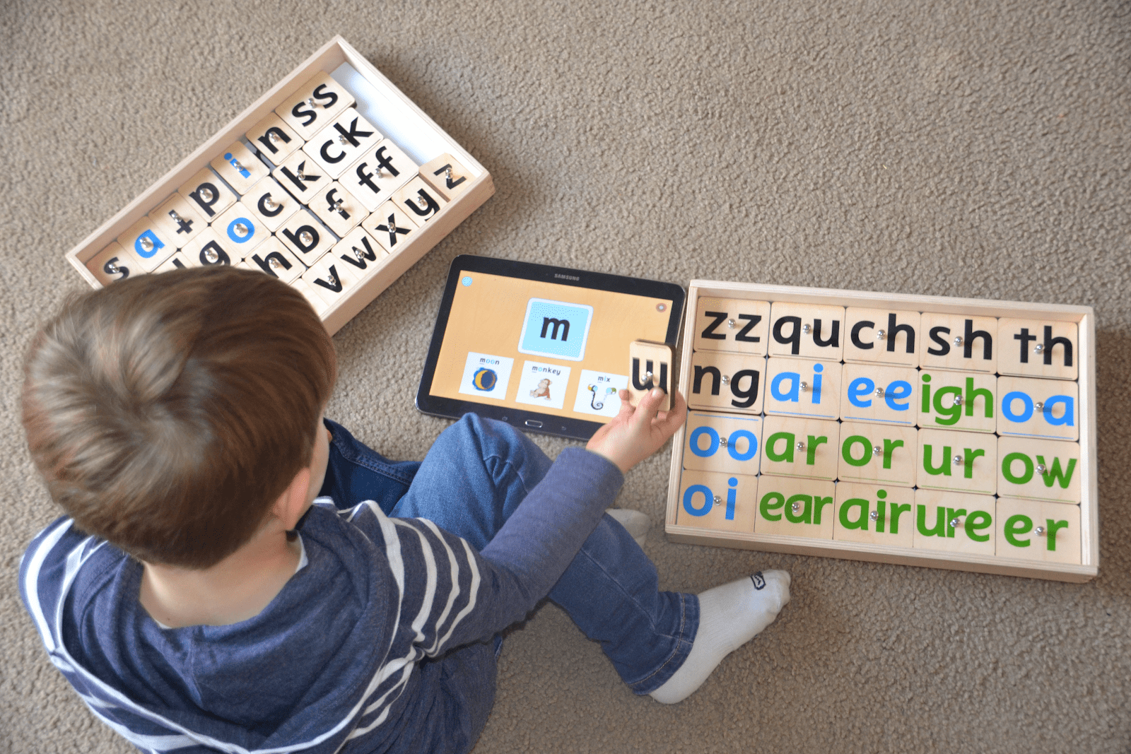 Boy Learning Phonics Using Resources