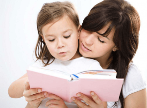 Parent and Child reading a book together using phonics