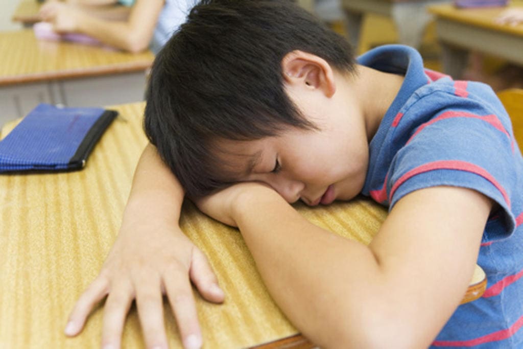 Singaporean boy falling asleep in class