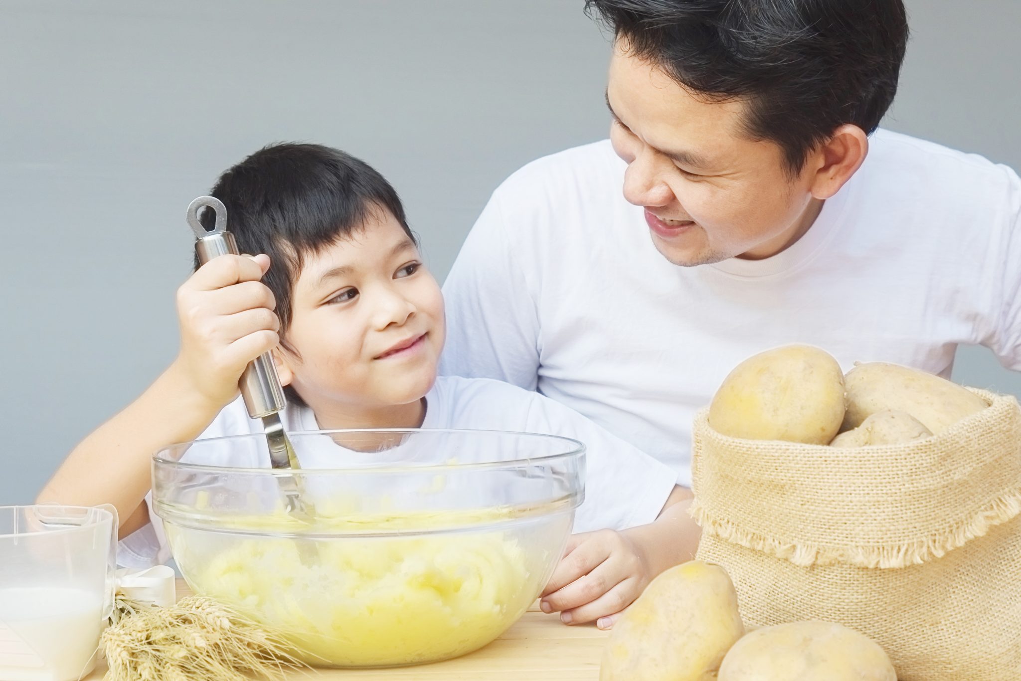 Daddy make. Child with a dish on his head. Asian father.