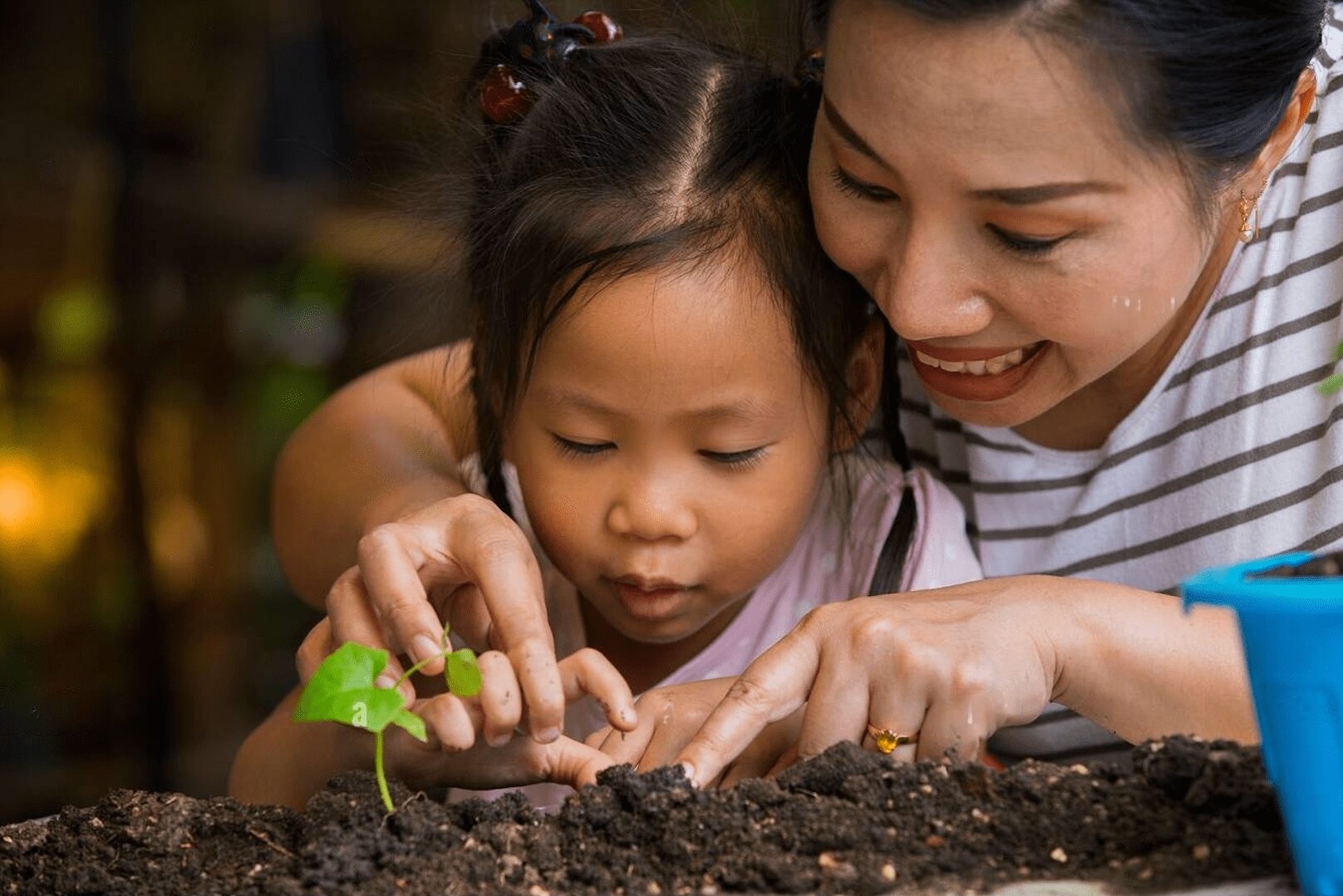 child gardening with mother