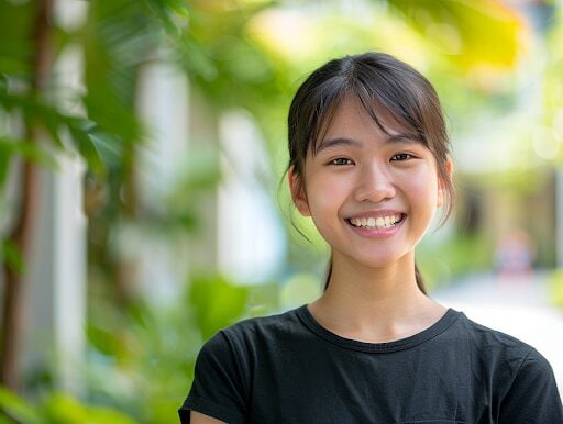 young-singaporean-girl-smiling-brightly-and-confidently-after-undergoing-invisalign-treatment-suitable-for-teenagers-for-discretion-comfort-and-convenience